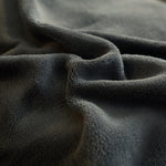 Textuur van grijs pluche stof close-up