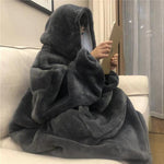 Persoon draagt een zwarte Sherpa Fleece XXL hoodie, liggend op de bank.